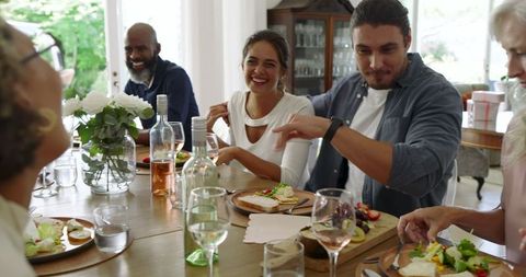 Close Group of Friends Enjoying Lively Lunch Indoors