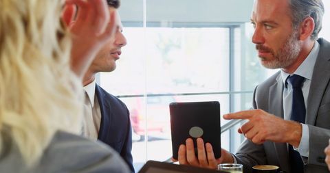 Business Meeting Discussion with Digital Tablet During Work