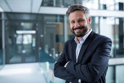 Confident Businessman in Modern Corporate Office