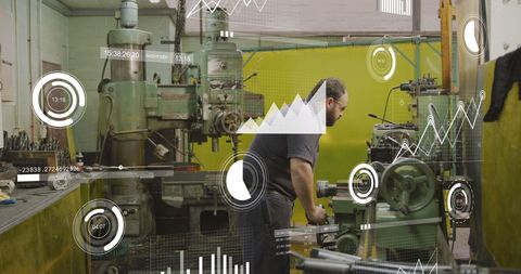 Caucasian Mechanic Operating Machinery with Digital Graphs Overlay