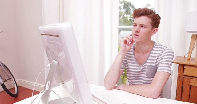 Young man working on desk in casual home environment - Download Free Stock Images Pikwizard.com