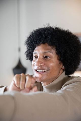 African american man leaning forward in home office environment