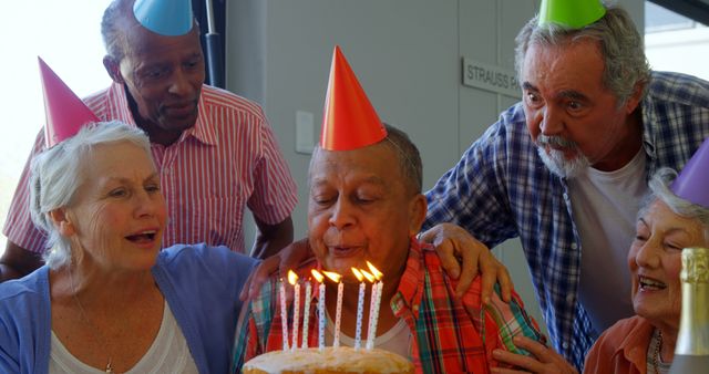 Joyful Birthday Celebration Among Senior Friends With Cake and Hats - Download Free Stock Images Pikwizard.com