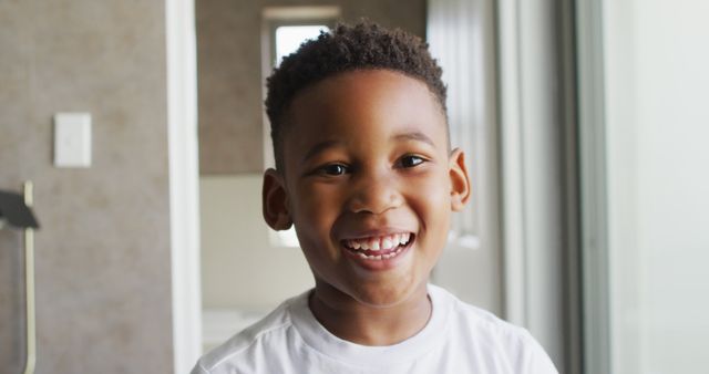 Image of african american boy smiling at camera. Childhood, spending free time at home concept.