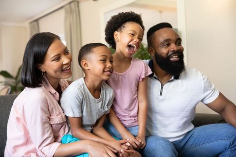 Happy Family Enjoying Quality Time Together on Sofa
