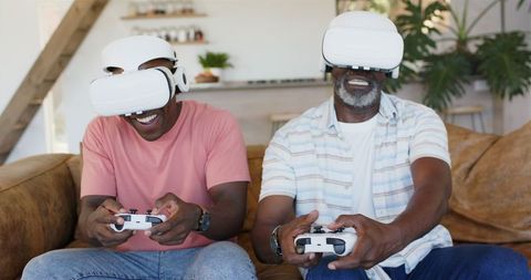 Father and Son Enjoying Virtual Gaming Experience with VR Headsets