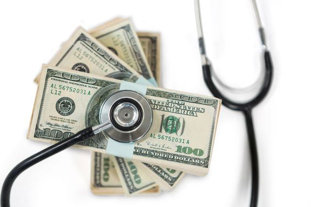 Stethoscope on Stack of US Dollar Bills - Download Free Stock Photos Pikwizard.com
