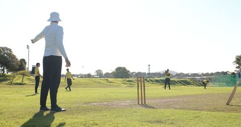 Cricket Umpire Signaling on Field During Game