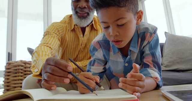 Elderly Man Assisting Young Boy with Homework - Download Free Stock Images Pikwizard.com