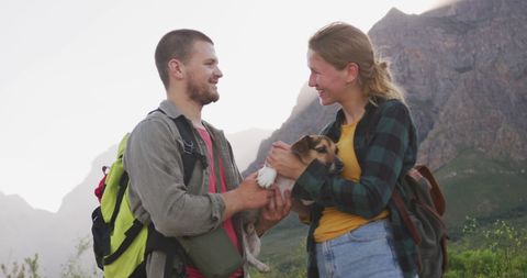 Happy Hikers Embracing Adventure with Beloved Pet in Scenic Mountains