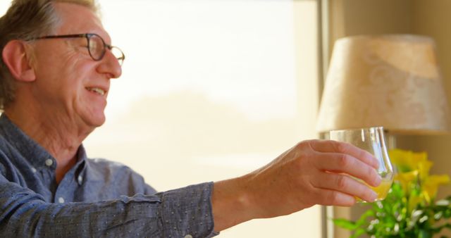 Senior Man Drinking Orange Juice in Bright Morning Room - Download Free Stock Images Pikwizard.com