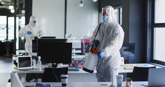 Cleaning Crew Disinfecting Office Workspace in Protective Suits - Download Free Stock Images Pikwizard.com