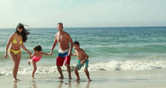 Family having fun on the beach in sunny weather. Ideal for travel advertisements, family vacation brochures, summer fun promotions, and health and lifestyle content focused on outdoor activities. Perfect for conveying themes of joy, bonding, and relaxation.