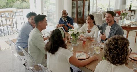 Family and Friends Enjoying Festive Home Celebration with Toast