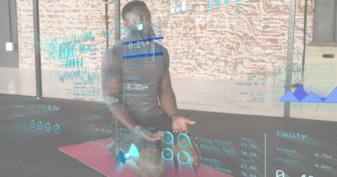 Kneeling athlete analyzing ar fitness analytics and holographic performance charts in gym