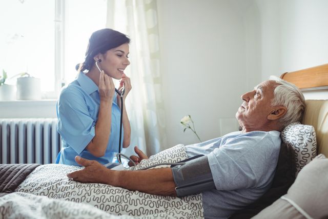 Nurse Checking Blood Pressure of Senior Man in Bedroom - Download Free Stock Photos Pikwizard.com