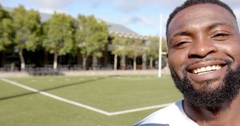Smiling African American Athlete on Sunny Turf Field