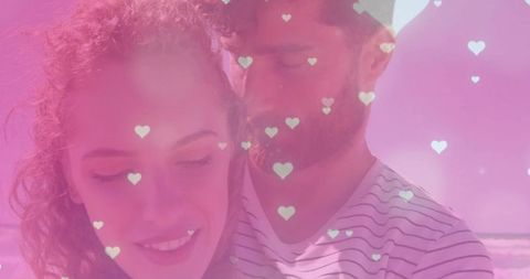 Romantic Couple Embracing on Beach with Heart Graphics