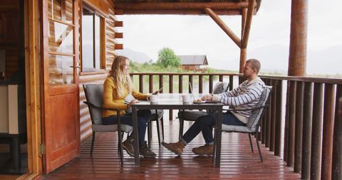 Couple Relaxing on Log Cabin Terrace In Peaceful Nature Scene - Download Free Stock Images Pikwizard.com