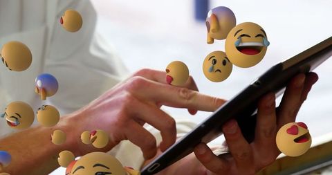 Digital Emojis Hovering Around Tablet: Exploring Modern Communication