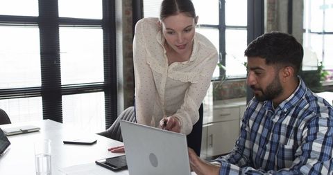 Colleagues Collaborating Over Laptop in Modern Office Space - Download Free Stock Images Pikwizard.com