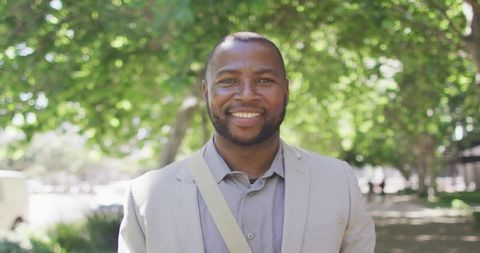 Smiling Professional Man in Sunlit Park