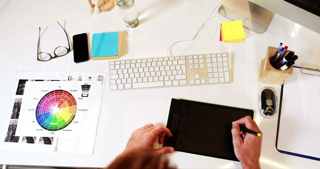 Graphic Designer Working with Color Wheel on Digital Tablet at Office Desk - Download Free Stock Images Pikwizard.com