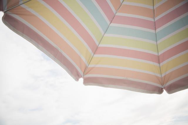 Low Angle View of Colorful Beach Umbrella Against Blue Sky - Download Free Stock Photos Pikwizard.com