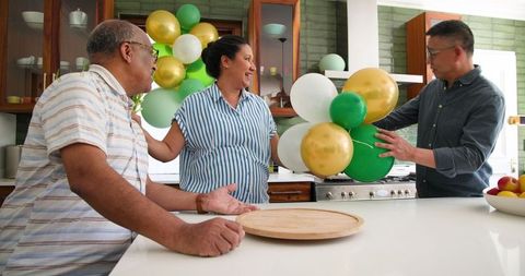 Seniors joyfully preparing party decorations with balloons