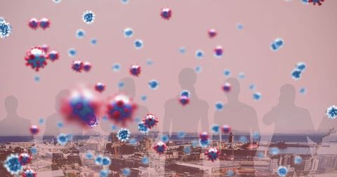 Covid-19 virus cells hovering over cityscape with silhouetted people