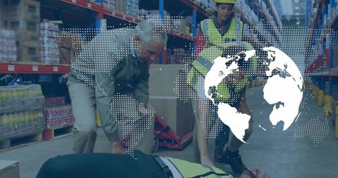 Emergency response team assisting injured worker in warehouse