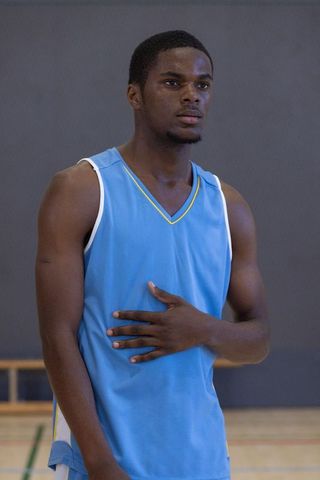 Athlete in Gymnasium Displaying Strength and Determination