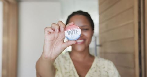 Young woman promoting voting with badge for civic engagement