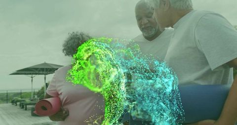 Seniors holding yoga mats, chatting on outdoor deck with colorful blue-green energy effect