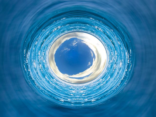 Depicts a mesmerizing whirlpool with the sky mirrored at the center of the vortex. Suitable for use in projects related to nature, meditation, tranquility, illusion, and motion. Perfect for websites, blogs, posters, and backgrounds emphasizing surreal and abstract themes.
