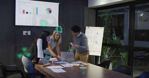 Professionals Discussing Analytics with Digital Elements in Modern Office