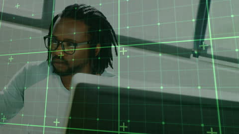 Businessman Using Computer with Financial Data Overlay