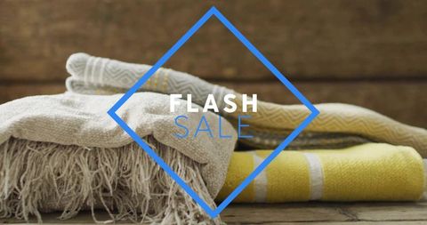 Displaying folded rustic textiles with beige throw and yellow towel for flash sale