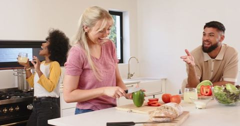Diverse Group of Friends Cooking in Modern Kitchen Warm Atmosphere