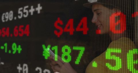 Professional woman checking currency rates on trading floor