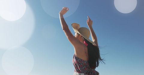 Joyful Woman Enjoying Beach Vacation Under Clear Blue Sky