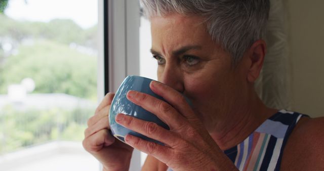 Elderly Woman Enjoying Morning Coffee by the Window - Download Free Stock Images Pikwizard.com