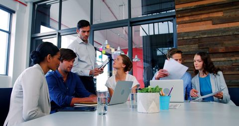 Diverse Team Engaging in Business Meeting in Modern Office
