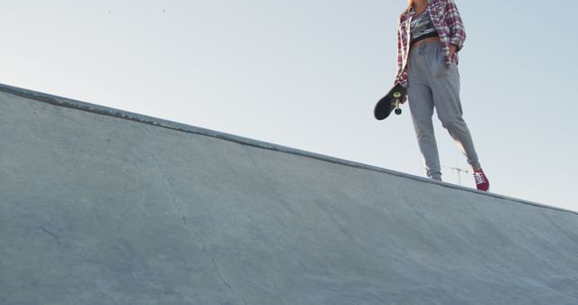 Teen Holding Skateboard at Skatepark on Sunny Day - Download Free Stock Images Pikwizard.com