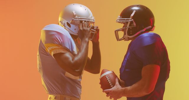 Two American football players from opposing teams face each other in an intense standoff. The vibrant gradient background adds energy to the scene, highlighting the competition and rivalry. Perfect for articles, advertisements, or promotional materials related to sports, teamwork, competitions, and athletic events.