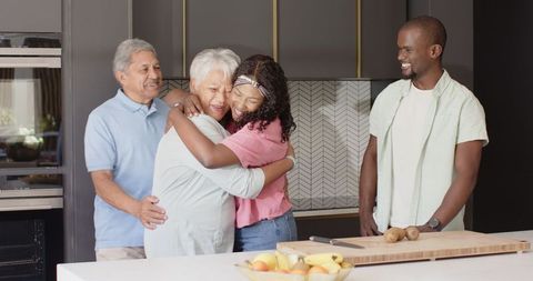 Multigenerational Family Embracing in Modern Kitchen