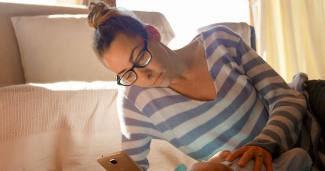 Young Mother with Baby Relaxing and Using Smartphone at Home - Download Free Stock Images Pikwizard.com