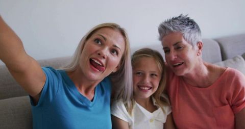 Multigenerational Family Capturing Happy Moments Together on Sofa