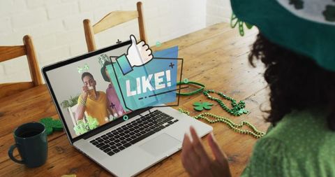 Woman in Shamrock Hat Video Calling with Friends on Laptop