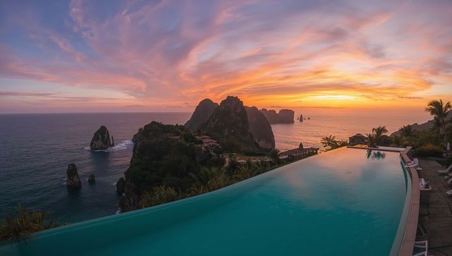 Cliffside infinity pool overlooking dramatic sunset views